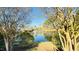 Scenic view of a community pond framed by trees, leading to a peaceful waterfront at 105 Cherry Grove Dr, Cary, NC 27519