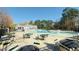 Large outdoor pool with ample seating and a white clubhouse in a community setting at 105 Cherry Grove Dr, Cary, NC 27519