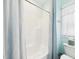 Bathroom with a bathtub, shower curtain, toilet and window creating a serene atmosphere at 10836 Connally Ln, Raleigh, NC 27614