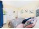 Cozy bedroom showcases a floral patterned bedspread, light yellow walls, and a white closet door at 10836 Connally Ln, Raleigh, NC 27614