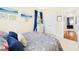 Bright bedroom with a floral comforter, plush pillows, and access to a hallway at 10836 Connally Ln, Raleigh, NC 27614
