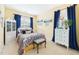 Bedroom featuring a white metal bed frame with an upholstered bench, and white cabinet with blue hardware at 10836 Connally Ln, Raleigh, NC 27614