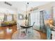 Bright breakfast nook with adjacent living room, colorful curtains, and pendant lighting at 10836 Connally Ln, Raleigh, NC 27614