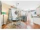 Charming breakfast nook with glass table, bright rug, and views into the kitchen at 10836 Connally Ln, Raleigh, NC 27614
