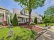 Two-story home with inviting front porch and mature tree providing shade at 10836 Connally Ln, Raleigh, NC 27614