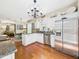 Spacious kitchen featuring white cabinets, granite countertops, and stainless steel appliances at 10836 Connally Ln, Raleigh, NC 27614