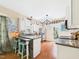 Well-lit kitchen featuring an island with bar seating and stainless steel appliances at 10836 Connally Ln, Raleigh, NC 27614