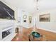 Bright living room featuring a fireplace, elegant chandelier, and gleaming hardwood floors at 10836 Connally Ln, Raleigh, NC 27614