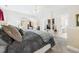 This large primary bedroom features a sitting area, ceiling fan, and en-suite bathroom at 10836 Connally Ln, Raleigh, NC 27614