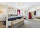 This primary bedroom offers a four-poster bed, sitting area, walk-in closet, and adjoining bathroom at 10836 Connally Ln, Raleigh, NC 27614