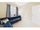 Sitting room featuring a plush blue sectional couch and accent tables near window at 10836 Connally Ln, Raleigh, NC 27614
