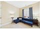 Sitting room showcasing a plush blue sectional couch and accent tables near window at 10836 Connally Ln, Raleigh, NC 27614