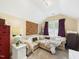 This upstairs sitting room features comfortable seating, neutral walls, and bright lighting at 10836 Connally Ln, Raleigh, NC 27614