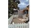 Cozy backyard patio area with white picket fence and string lights creating a warm ambiance at 11003 Louson Pl, Raleigh, NC 27614