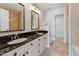 Bathroom featuring dual sinks, a black countertop, and tile floors at 11003 Louson Pl, Raleigh, NC 27614