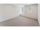 Spacious carpeted bedroom with ample natural light from dual windows at 11003 Louson Pl, Raleigh, NC 27614