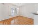Bright dining area features hardwood floors, large window, and elegant light fixture at 11003 Louson Pl, Raleigh, NC 27614