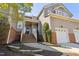 Charming townhome with brick accents, an inviting front porch and well maintained landscaping at 11003 Louson Pl, Raleigh, NC 27614