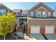 Charming townhome featuring brick accents, a two-car garage, and inviting front porch at 11003 Louson Pl, Raleigh, NC 27614