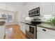 Bright kitchen featuring stainless steel appliances and white cabinets with granite countertops at 11003 Louson Pl, Raleigh, NC 27614