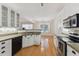 Open kitchen with white cabinetry, granite countertops, and stainless steel appliances at 11003 Louson Pl, Raleigh, NC 27614