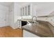 Charming kitchen boasts granite counters, stainless sink and black appliances at 11003 Louson Pl, Raleigh, NC 27614
