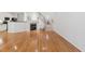 Open concept living room with hardwood floors, fireplace, kitchen and staircase at 11003 Louson Pl, Raleigh, NC 27614