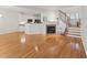 Open concept living room with hardwood floors, fireplace, kitchen and staircase at 11003 Louson Pl, Raleigh, NC 27614