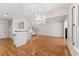 Inviting living room with hardwood floors, modern lighting, and stairway access at 11003 Louson Pl, Raleigh, NC 27614