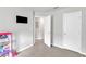 Neutral bedroom with two white paneled doors and television at 1107 Pale Moss Dr, Durham, NC 27704