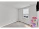An empty bedroom with a window and carpeted floors at 1107 Pale Moss Dr, Durham, NC 27704