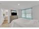 Bright bedroom with attached bathroom, TV, dresser, and carpeted floor at 1107 Pale Moss Dr, Durham, NC 27704