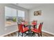 A small dining area with a glass table, red chairs, and a view of the outside at 1107 Pale Moss Dr, Durham, NC 27704