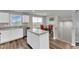 Bright eat-in kitchen with stainless steel dishwasher, white cabinets, and a view of the backyard at 1107 Pale Moss Dr, Durham, NC 27704