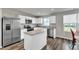 Well-equipped kitchen featuring stainless steel appliances, white cabinets, and a functional center island at 1107 Pale Moss Dr, Durham, NC 27704