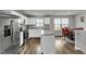 Modern kitchen with stainless steel appliances, white cabinets, and center island with dining area at 1107 Pale Moss Dr, Durham, NC 27704