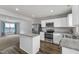 Bright kitchen features stainless steel appliances, white cabinets and gray and white countertops at 1107 Pale Moss Dr, Durham, NC 27704
