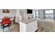 A view of the kitchen island with gray and white countertops in a room with carpet and a small dining area at 1107 Pale Moss Dr, Durham, NC 27704