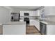 Bright kitchen features stainless steel appliances, white cabinets and gray and white countertops at 1107 Pale Moss Dr, Durham, NC 27704