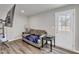 Cozy living room featuring a comfortable couch, TV, and access to the outdoors at 1107 Pale Moss Dr, Durham, NC 27704