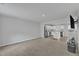 Open-concept living room next to a kitchen area with stainless steel appliances at 1107 Pale Moss Dr, Durham, NC 27704