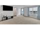 A living room with carpet, TV, and natural light coming from the windows at 1107 Pale Moss Dr, Durham, NC 27704