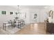 Elegant dining area featuring modern chandelier, glass top table, and bright windows, a perfect setting at 111 Silver Moon Ln # 121, Clayton, NC 27527
