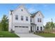 Beautiful two-story white home featuring a two-car garage and a well-manicured lawn, creating a welcoming curb appeal at 111 Silver Moon Ln # 121, Clayton, NC 27527