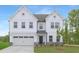 Charming two-story white home with a two-car garage, green grass, and a welcoming front entrance at 111 Silver Moon Ln # 121, Clayton, NC 27527