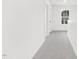 Upstairs hallway featuring neutral carpeting and a window providing natural light at 111 Silver Moon Ln # 121, Clayton, NC 27527