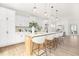 Modern kitchen with sleek white cabinetry, large island, and stylish pendant lights, creating an inviting space at 111 Silver Moon Ln # 121, Clayton, NC 27527