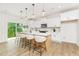 Bright kitchen featuring a large island with seating, modern appliances, and stylish pendant lighting above at 111 Silver Moon Ln # 121, Clayton, NC 27527