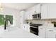 Well-equipped kitchen with white cabinets, stainless steel appliances, and quartz countertops offering an inviting cooking space at 111 Silver Moon Ln # 121, Clayton, NC 27527