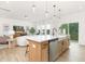 Open-concept kitchen with island seating flows into a cozy living area, perfect for modern living and entertaining at 111 Silver Moon Ln # 121, Clayton, NC 27527